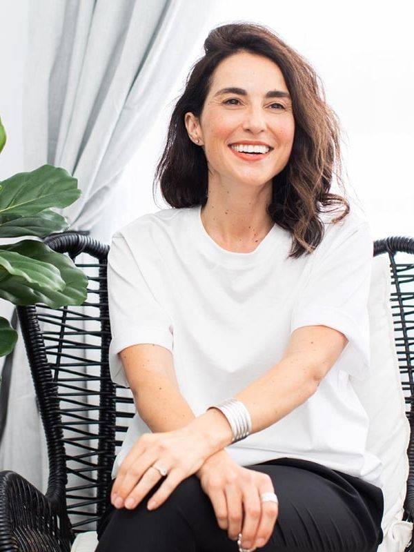 Alexandra Middleton a Naturopathic Nutritionist sitting on a chain in Australia in a women's health clinic